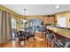 Open dining area with hardwood floors, bar seating, and access to an outdoor deck at 4005 Saddlebrook Creek Dr, Marietta, GA 30060