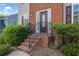 Close up of the front entrance with brick steps and wrought iron railing at 4005 Saddlebrook Creek Dr, Marietta, GA 30060