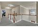 Upstairs hallway with neutral paint, white railing and carpet at 4005 Saddlebrook Creek Dr, Marietta, GA 30060