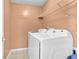Bright laundry room with side by side washer and dryer and shelving at 4005 Saddlebrook Creek Dr, Marietta, GA 30060