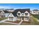 Birds eye view of a modern suburban home with a manicured lawn and black roof at 7785 Wild Violet Dr, Cumming, GA 30040