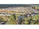 An aerial view shows a neighborhood next to a body of water, with a large wooded area in the background at 7785 Wild Violet Dr, Cumming, GA 30040