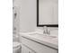 Bathroom with a single sink vanity, a combination shower and tub, and marble accents at 7785 Wild Violet Dr, Cumming, GA 30040