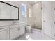 A modern bathroom with a glass-enclosed shower, marble-like tile, and sleek fixtures at 7785 Wild Violet Dr, Cumming, GA 30040