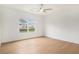 Bedroom featuring hardwood floors, neutral paint, and a window with neighborhood views at 7785 Wild Violet Dr, Cumming, GA 30040