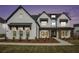 Beautiful home exterior featuring a brick facade, dark shutters, and well-maintained landscaping at 7785 Wild Violet Dr, Cumming, GA 30040