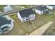 A beautiful, modern two-story home with a black roof and white walls and a spacious backyard at 7785 Wild Violet Dr, Cumming, GA 30040