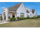 Beautiful community clubhouse featuring a covered porch, lush landscaping, and a welcoming entrance at 7785 Wild Violet Dr, Cumming, GA 30040