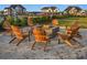 Outdoor firepit with Adirondack chairs, perfect for entertaining in a cozy community setting at 7785 Wild Violet Dr, Cumming, GA 30040