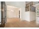 A foyer features hardwood floors, a staircase with black railings, and access to dining and living areas at 7785 Wild Violet Dr, Cumming, GA 30040