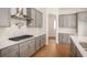 A modern kitchen with a gas stove, gray cabinets and countertops, and stylish hardware at 7785 Wild Violet Dr, Cumming, GA 30040
