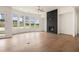Spacious living room with hardwood floors, a cozy fireplace, and plenty of natural light at 7785 Wild Violet Dr, Cumming, GA 30040