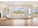 Bright, open living room with hardwood floors, fireplace, and backyard views at 7785 Wild Violet Dr, Cumming, GA 30040