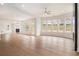 Spacious living room with fireplace, hardwood floors, recessed lighting, and large windows at 7785 Wild Violet Dr, Cumming, GA 30040