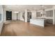Spacious open-concept living area featuring a modern fireplace and adjacent kitchen with a large island at 7785 Wild Violet Dr, Cumming, GA 30040