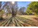Spacious backyard area with mature trees and play set equipment at 105 Ruff Harris Dr, Dallas, GA 30157