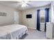 Bedroom with carpet, a window, a wall-mounted TV, and white walls at 105 Ruff Harris Dr, Dallas, GA 30157