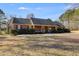 Ranch-style brick home with a dark roof, manicured shrubs, and a welcoming front porch at 105 Ruff Harris Dr, Dallas, GA 30157