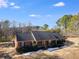 Brick home featuring a charming front porch and mature trees in a tranquil setting at 105 Ruff Harris Dr, Dallas, GA 30157