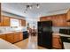 Well-lit kitchen with wood cabinets, modern appliances, and an adjacent dining area at 105 Ruff Harris Dr, Dallas, GA 30157