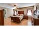 Main bedroom featuring a wooden bed frame, side tables, and neutral walls at 105 Ruff Harris Dr, Dallas, GA 30157
