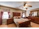 Spacious main bedroom with hardwood floors, a ceiling fan, and neutral decor at 105 Ruff Harris Dr, Dallas, GA 30157