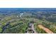 Aerial view of the neighborhood with custom homes surrounded by mature trees, featuring a river running nearby at 302 Grant Ct, Canton, GA 30114