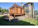 The backyard wooden deck features a stylish pergola, adding charm and space to entertain at 302 Grant Ct, Canton, GA 30114