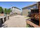 Spacious backyard patio featuring an outdoor kitchen, brick pavers, and well-maintained landscaping at 302 Grant Ct, Canton, GA 30114