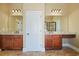 Bathroom boasts double vanities with granite counters, dark wood cabinets, and decorative light fixtures at 302 Grant Ct, Canton, GA 30114