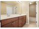 Bright bathroom with double sinks, wood cabinets, and a large mirror at 302 Grant Ct, Canton, GA 30114