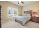 Cozy bedroom showcasing a wooden bed frame, nightstand, and a bright window view at 302 Grant Ct, Canton, GA 30114