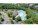 Aerial view of a community pool, water slide, clubhouse, and lake at 302 Grant Ct, Canton, GA 30114