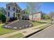 Charming two-story home with a beautifully landscaped front yard and inviting curb appeal on a sunny day at 302 Grant Ct, Canton, GA 30114