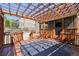 Back deck features a hot tub covered for the winter months and a covered outdoor seating area at 302 Grant Ct, Canton, GA 30114