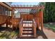 Outdoor hot tub area with a wooden pergola and fence for privacy and shade on the back porch at 302 Grant Ct, Canton, GA 30114