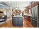 Spacious kitchen featuring center island, stainless appliances, granite counters, and hardwood floors at 302 Grant Ct, Canton, GA 30114