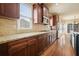 A modern kitchen with granite counters, tile backsplash, stainless steel appliances, and hardwood floors at 302 Grant Ct, Canton, GA 30114
