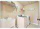 Functional laundry room with modern washer and dryer and built-in shelving at 302 Grant Ct, Canton, GA 30114
