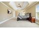 Spacious bedroom with tray ceilings, ceiling fan and a large window at 302 Grant Ct, Canton, GA 30114