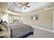 Spacious bedroom with tray ceilings, ceiling fan and a large window at 302 Grant Ct, Canton, GA 30114