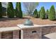 Outdoor kitchen with stone countertop, built-in grill, and manicured landscaping at 302 Grant Ct, Canton, GA 30114