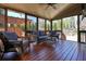 Inviting screened porch with wicker furniture, ceiling fan, and wood flooring at 302 Grant Ct, Canton, GA 30114