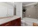 Bathroom features a bathtub with tile surround, granite vanity, and modern fixtures at 400 W West Peachtree Nw St, Atlanta, GA 30308