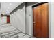 Hallway entrance of a condo unit with wood door and stylish carpet at 400 W West Peachtree Nw St, Atlanta, GA 30308