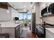 Modern kitchen features a breakfast bar, stainless steel appliances, and open concept layout with city views at 400 W West Peachtree Nw St, Atlanta, GA 30308