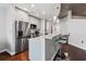 Modern kitchen features stainless appliances, ample cabinet space, and a breakfast bar with seating at 400 W West Peachtree Nw St, Atlanta, GA 30308