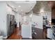 Modern kitchen features stainless steel appliances, island with bar seating, and hardwood floors at 400 W West Peachtree Nw St, Atlanta, GA 30308