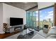 Modern living room featuring sleek furniture, an electric fireplace, and panoramic city views at 400 W West Peachtree Nw St, Atlanta, GA 30308
