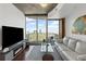 Living room featuring a comfortable sofa and large windows showcasing an urban view at 400 W West Peachtree Nw St, Atlanta, GA 30308